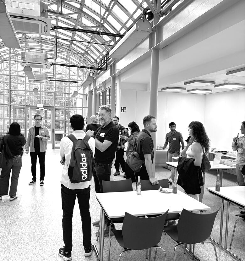 Guests standing and talking in a bright room
