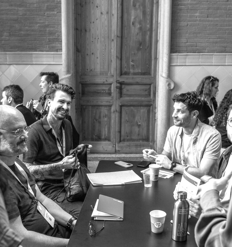 Designers laughing around a table